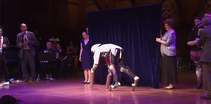 Thomas Thwaites on stage at Harvard University to collect his Ig Nobel. Improbable Research/YouTube
